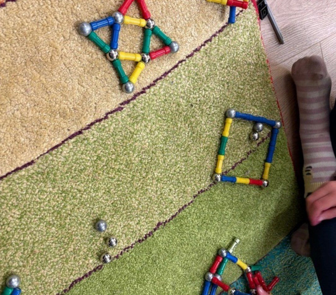 Magnetic building shapes on a carpet