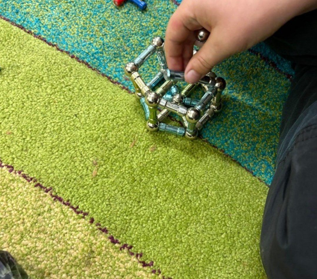 A child building with magnetic sticks