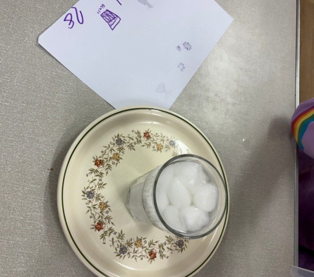 Cotton wool in a glass on a patterned plate