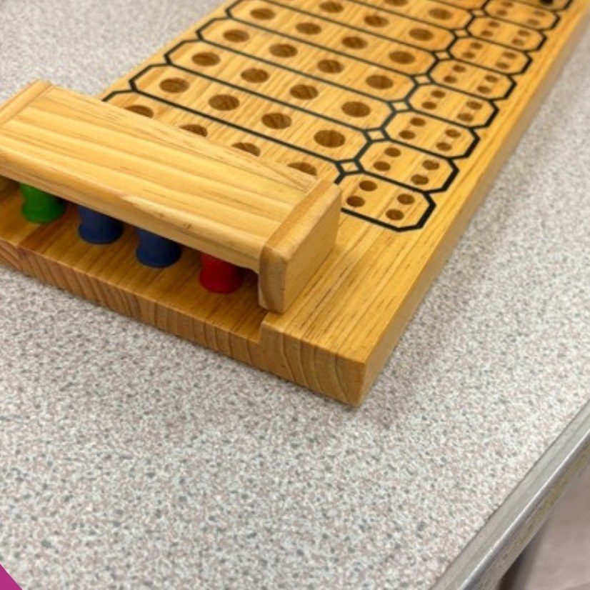 A wooden peg board counting game
